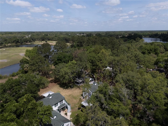 birds eye view of property with a wooded view and a water view