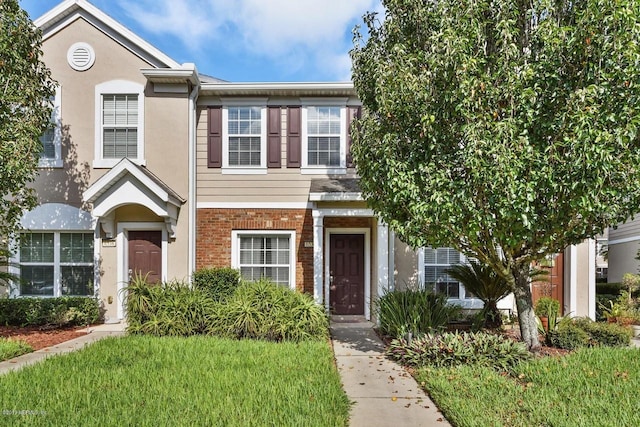 view of property featuring a front lawn