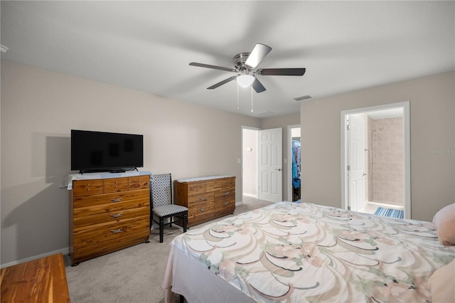 bedroom featuring ceiling fan, light carpet, and ensuite bathroom