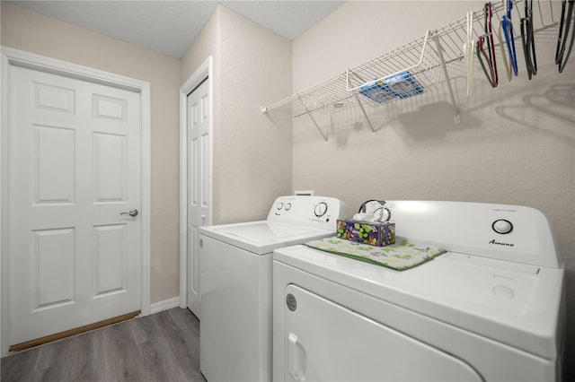 washroom with independent washer and dryer and dark hardwood / wood-style floors