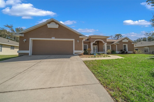 ranch-style house with an attached garage, a front lawn, concrete driveway, and stucco siding