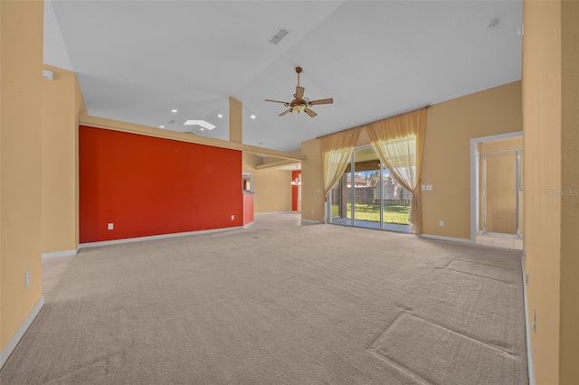 unfurnished living room featuring lofted ceiling, light colored carpet, visible vents, a ceiling fan, and baseboards