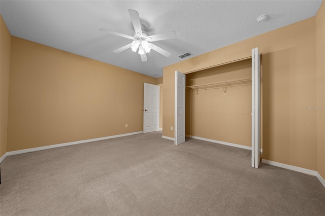 unfurnished bedroom featuring light carpet, baseboards, visible vents, a ceiling fan, and a closet