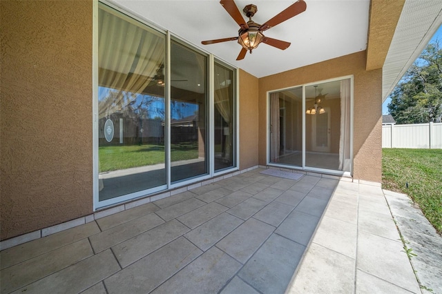 view of patio featuring ceiling fan and fence