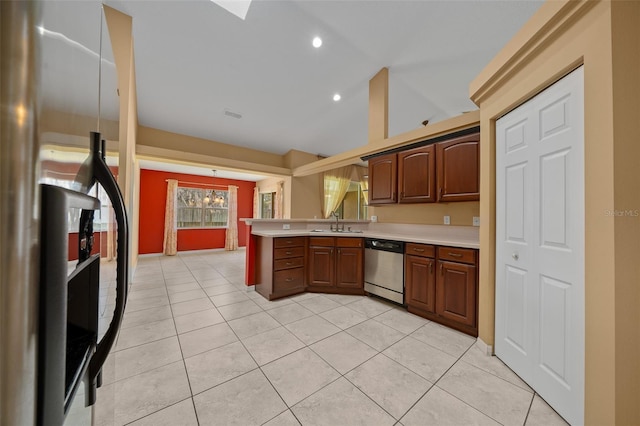 kitchen with dishwasher, a peninsula, vaulted ceiling, light countertops, and refrigerator with ice dispenser