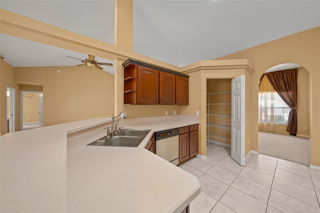 kitchen with open shelves, light countertops, stainless steel dishwasher, light tile patterned flooring, and a sink