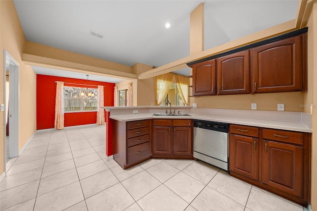 kitchen featuring light tile patterned floors, a peninsula, light countertops, stainless steel dishwasher, and a sink