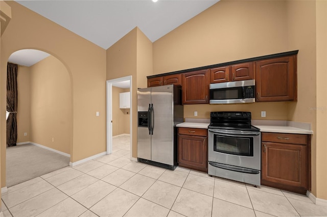 kitchen with light tile patterned floors, stainless steel appliances, and light countertops