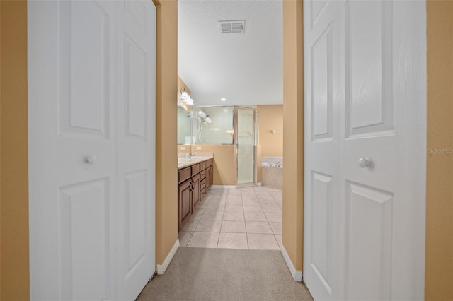 bathroom featuring a stall shower, a closet, visible vents, vanity, and a bath