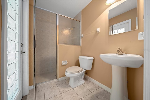 full bathroom with baseboards, a shower stall, toilet, and tile patterned floors