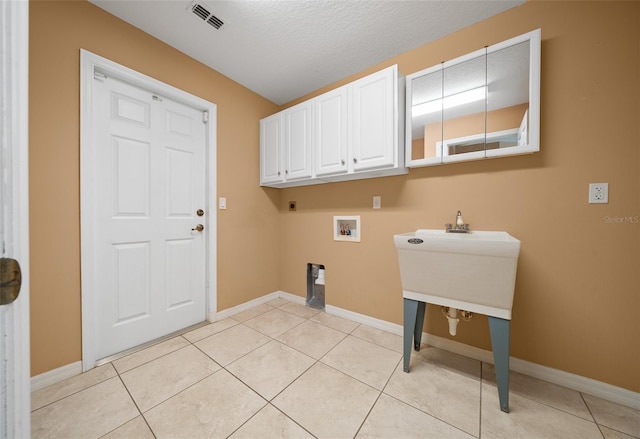 clothes washing area featuring hookup for a washing machine, baseboards, visible vents, and cabinet space