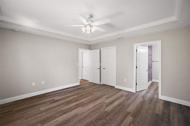 unfurnished bedroom with dark wood-style floors, visible vents, and baseboards