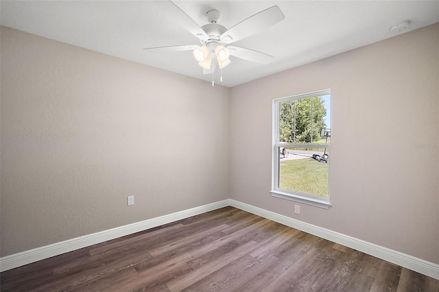 empty room with a ceiling fan, baseboards, and wood finished floors