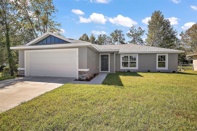 single story home with stucco siding, an attached garage, a front yard, stone siding, and driveway