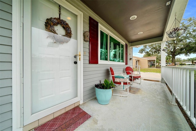 view of exterior entry featuring a porch