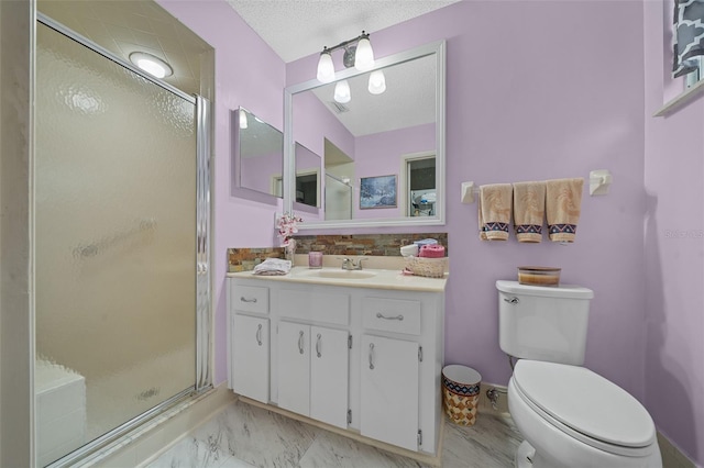 bathroom featuring a textured ceiling, toilet, vanity, marble finish floor, and a stall shower