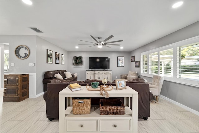 living room with baseboards, visible vents, a ceiling fan, and recessed lighting