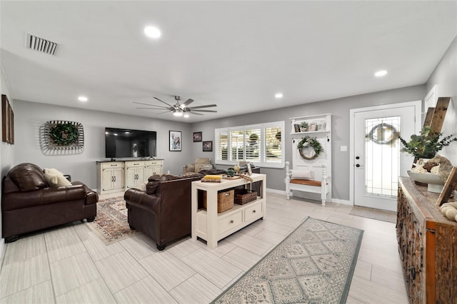 living room featuring ceiling fan, visible vents, baseboards, and recessed lighting