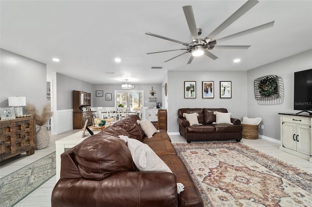 living room with recessed lighting, visible vents, and ceiling fan with notable chandelier