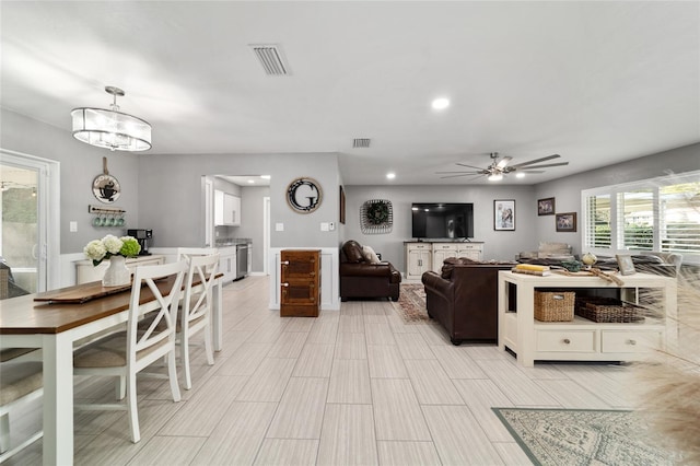 living area featuring ceiling fan, visible vents, and recessed lighting