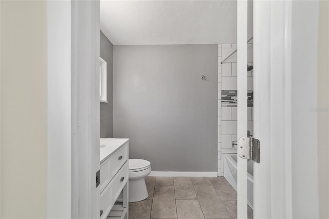 full bath with tile patterned floors, vanity, toilet, and baseboards