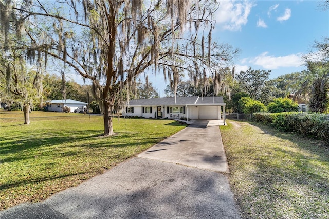 ranch-style house with a garage, aphalt driveway, and a front yard