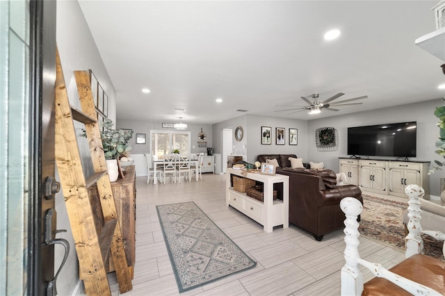 living room with a ceiling fan and recessed lighting