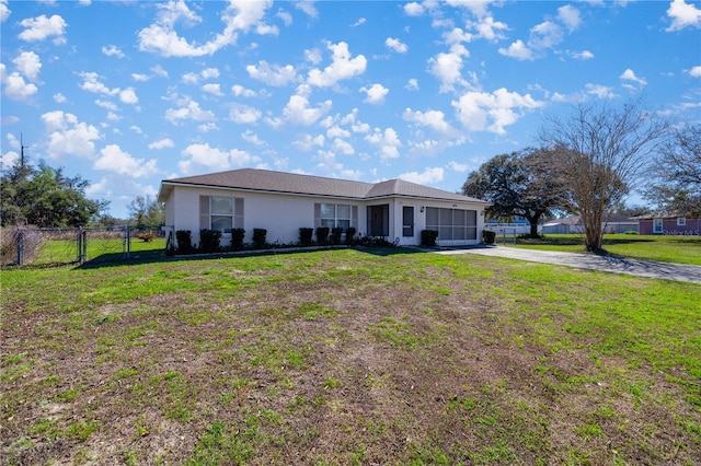 ranch-style home with a garage and a front yard