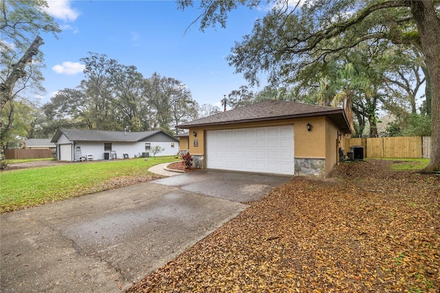 ranch-style home with stucco siding, an attached garage, fence, cooling unit, and stone siding