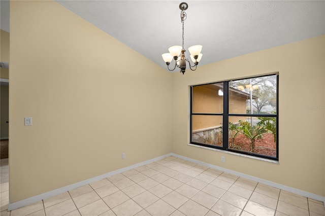 empty room featuring a notable chandelier, baseboards, and light tile patterned floors