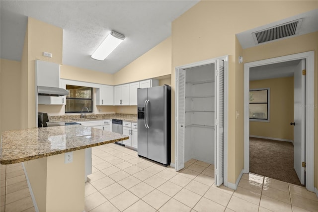 kitchen with visible vents, appliances with stainless steel finishes, a breakfast bar area, white cabinetry, and a sink