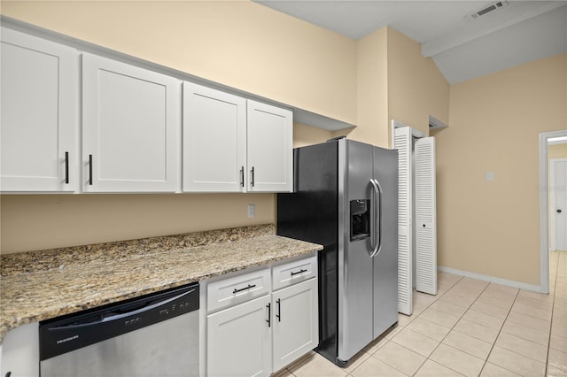 kitchen with light tile patterned floors, stainless steel appliances, visible vents, white cabinetry, and light stone countertops