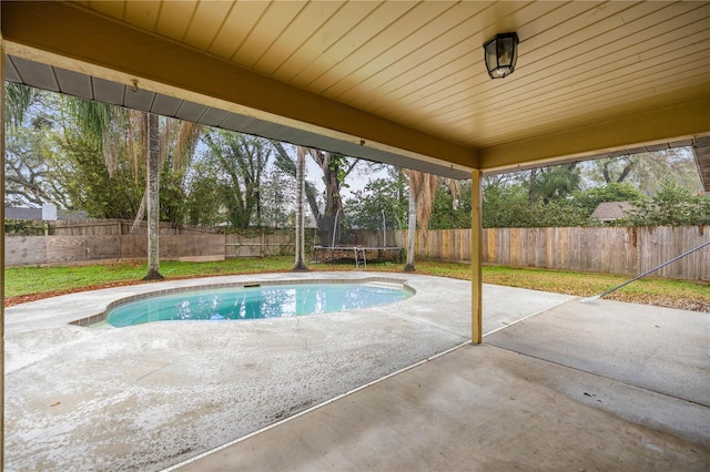 view of patio / terrace featuring a fenced backyard and a trampoline