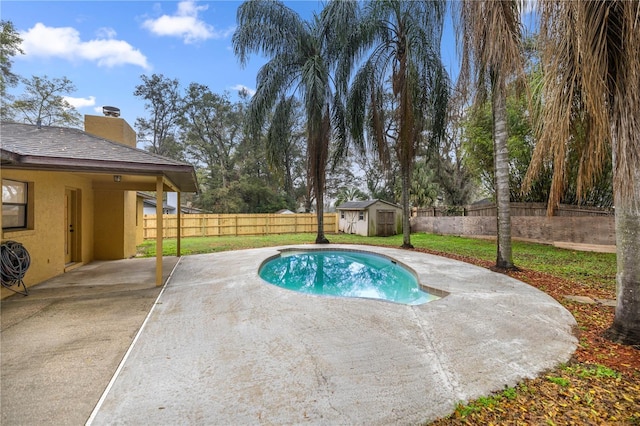 view of pool featuring a fenced in pool, an outbuilding, a storage shed, a patio area, and a fenced backyard