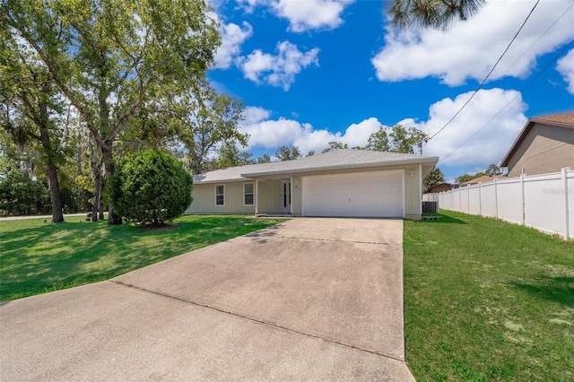 view of front of house featuring central air condition unit, a front lawn, and a garage