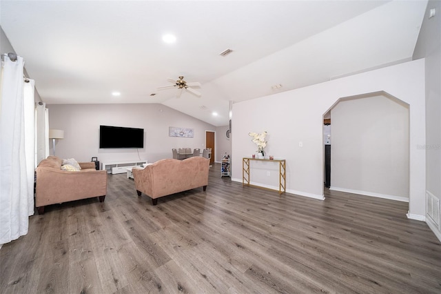 living room featuring dark hardwood / wood-style flooring, ceiling fan, and vaulted ceiling