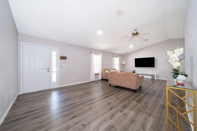 living room featuring dark hardwood / wood-style flooring, ceiling fan, and vaulted ceiling