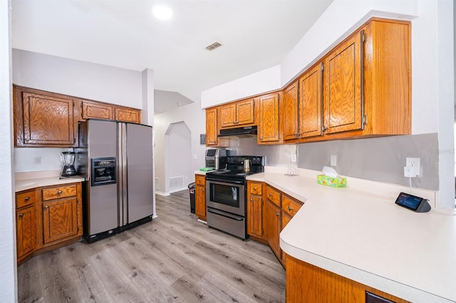 kitchen featuring light hardwood / wood-style floors, lofted ceiling, and stainless steel appliances