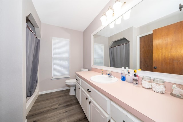 bathroom featuring hardwood / wood-style flooring, toilet, vanity, and a shower with shower curtain