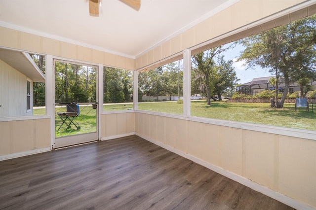 unfurnished sunroom featuring ceiling fan