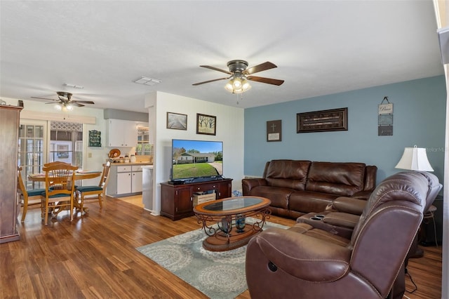 living room with hardwood / wood-style floors and ceiling fan