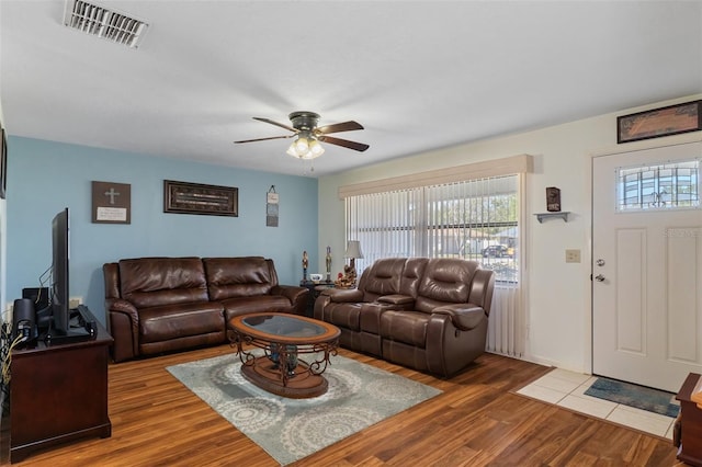 living room featuring hardwood / wood-style flooring and ceiling fan