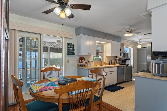 dining space with ceiling fan and sink