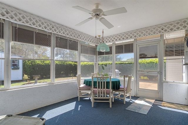 sunroom featuring ceiling fan