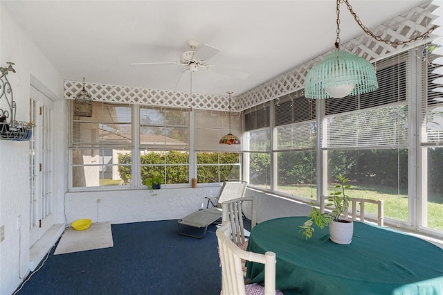 sunroom featuring ceiling fan