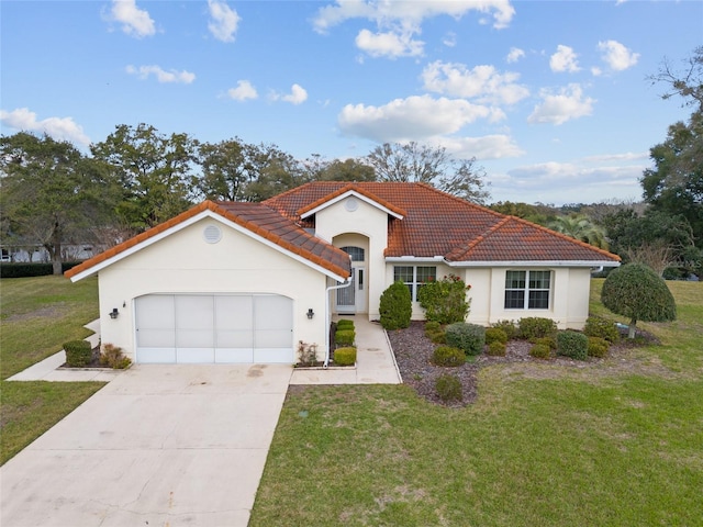 mediterranean / spanish-style home with a garage, driveway, a tile roof, a front lawn, and stucco siding