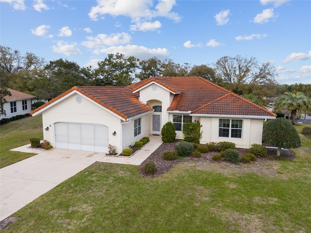 mediterranean / spanish home featuring a front yard, concrete driveway, a tile roof, and an attached garage