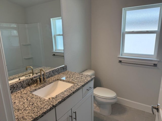 full bathroom with baseboards, a shower, toilet, and vanity