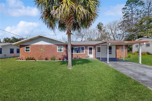 ranch-style house with driveway, an attached carport, and a front yard