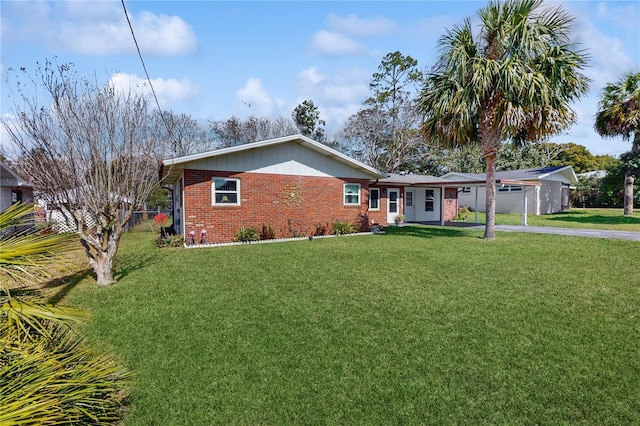 ranch-style house with a garage, aphalt driveway, a front yard, and brick siding